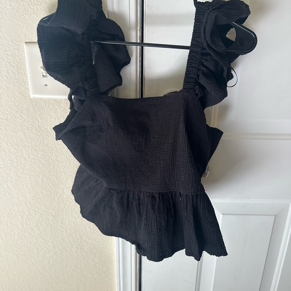 Black top with ruffle sleeves